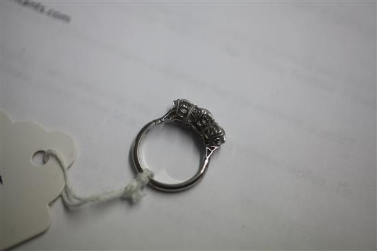 A mid 20th century white gold and three stone diamond ring, size closed, K.